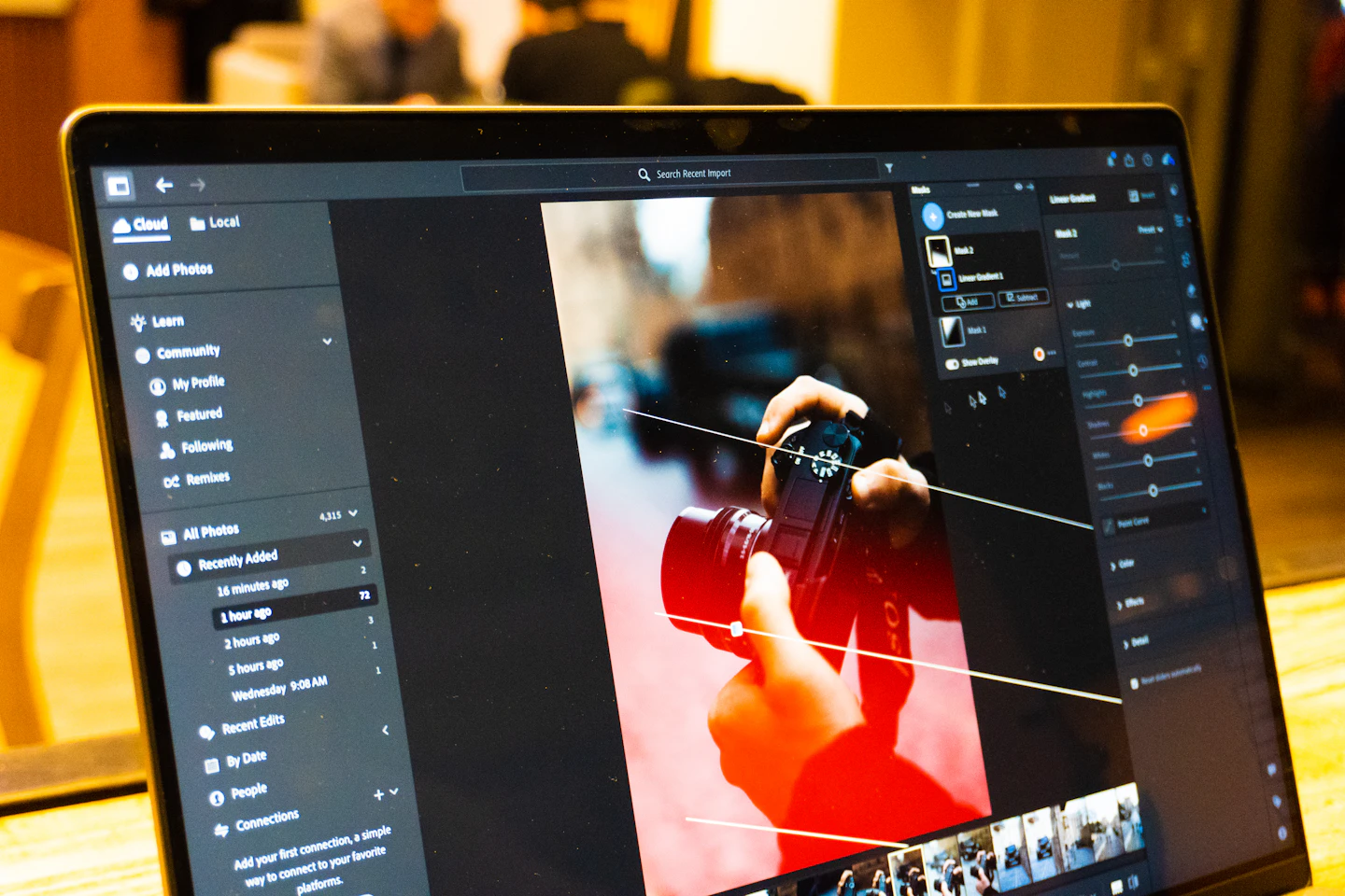 Photo editing software is shown on a laptop screen